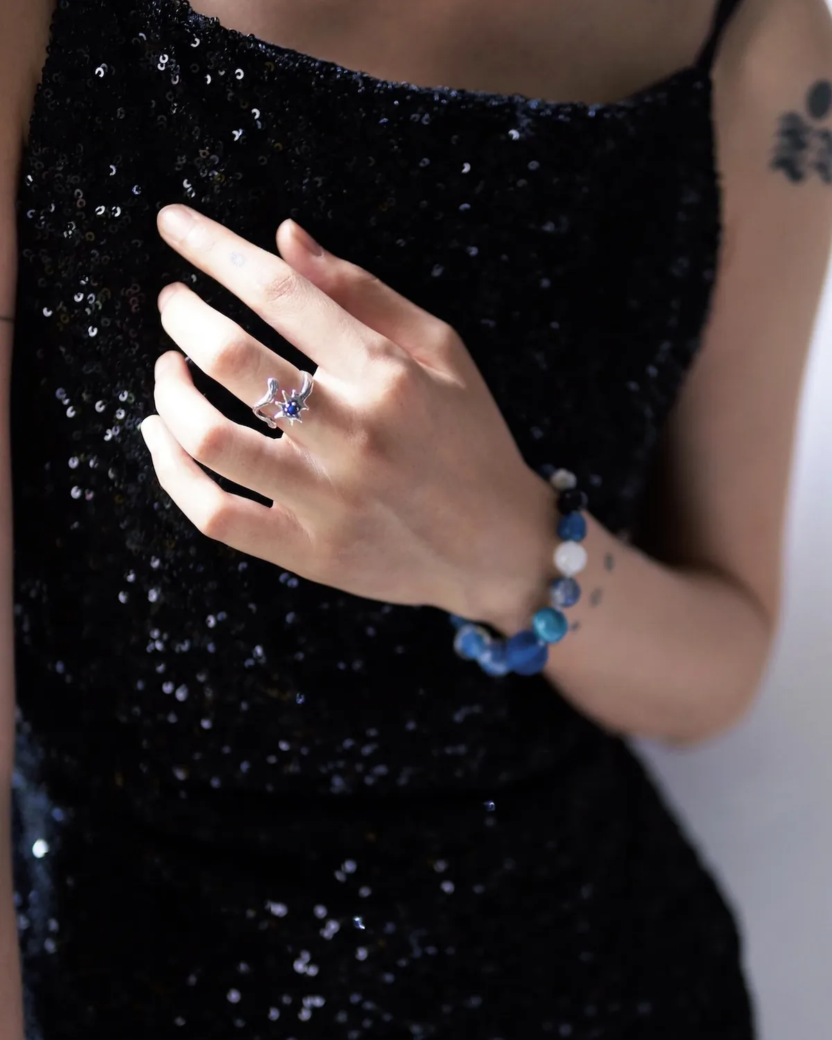 Night Wish Lapis Lazuli Silver Ring Worn Night Wish silver star ring with a small blue lapis lazuli stone worn against a black dress