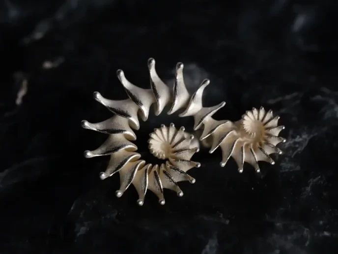 Twin Spiral Ring — Before Cleaning, Front Twin spiral silver ring before cleaning, viewed from the front on dark marble